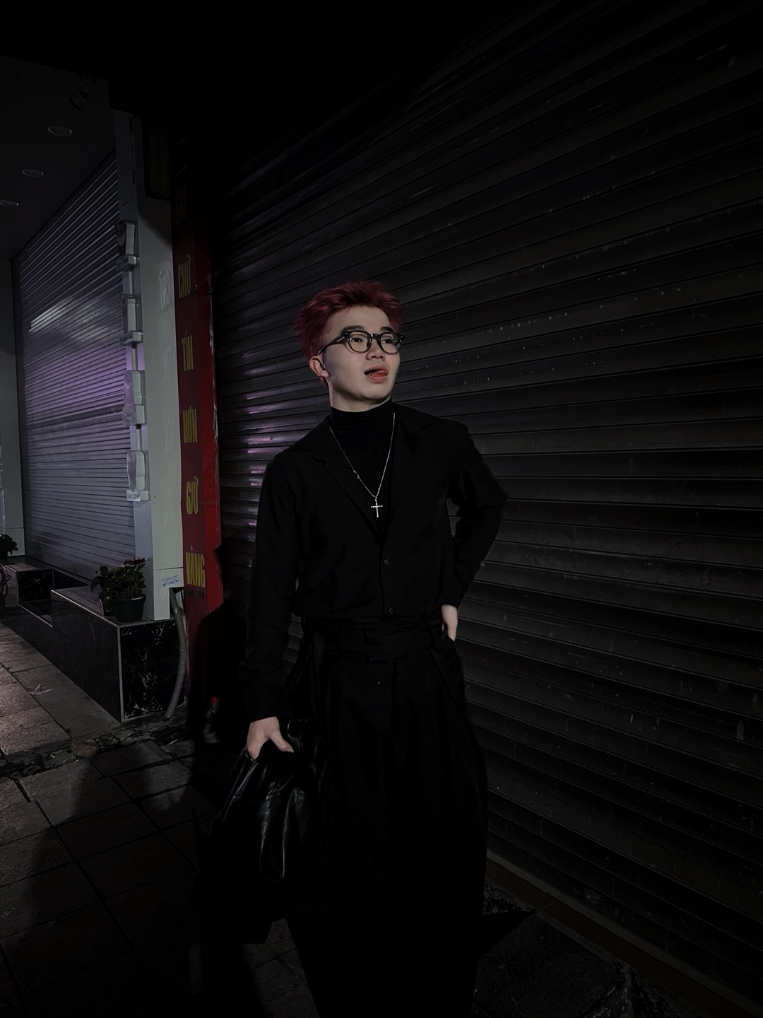QUOC TUAN in a dark urban night environment with black shutter background